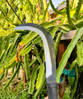 Close-up of Tough As Nails Sickle Machete For Yard Work With Carbon Steel Blade, 14 Inch Short Machete used for clearing overgrown plants.