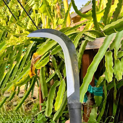 Close-up of Tough As Nails Sickle Machete For Yard Work With Carbon Steel Blade, 14 Inch Short Machete used for clearing overgrown plants.