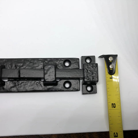 Rock Solid Heavy Duty Cast Iron Sliding Door Bolt Latch 5 Inch Mounting Plate with tape measure for scale