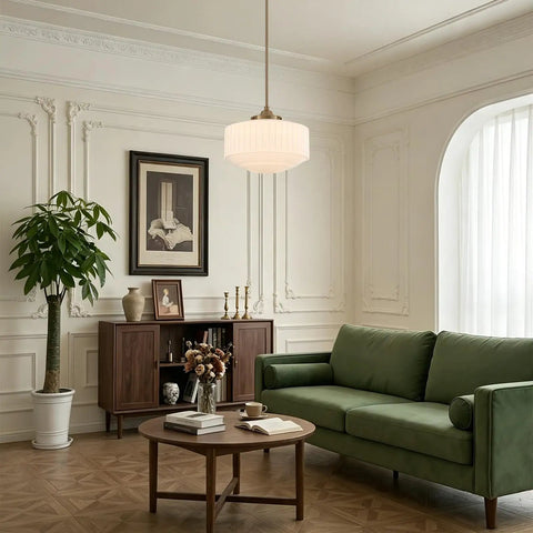 Vintage Brass Milk Glass Pendant Light 13.8in White Pleated Chandelier, E26 hanging over a green sofa in a stylish living room.