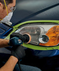 Person using Ultra Headlight Restoration Kit With Masking Tape Sanding Discs Finishing Discs Refining Disc Wax Protectant Clear Coat
