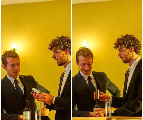 Two men in suits using a No Brainer Push Button Beer Foam Maker at a bar to create frosty beer foam.
