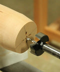 Close up of Premium Four Piece Forstner Bit Set Built For No Headache Splinter Free Cuts with wood piece being drilled.