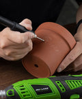 Person using 180W Rotary Tool Kit With 6 Variable Speeds And Flex Shaft 8000 To 32000 RPM All In One Heavy Duty Power Tool Workhorse