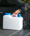 Person placing 4 Gallon Camping Water Jug With Spigot For Emergency Water Storage Outdoors into car trunk