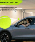 Dnairtly garage parking aid with neon green tennis-ball hanging from ceiling beside a car.