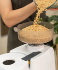 Pouring grains into Beefy 1200W High Speed Electric Grain Mill For Fresh Flour Compact Impact Grinder With Stainless Steel Milling Heads Wheat Grinder For Smooth Bread Flour Texture