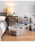 Straight Up Premium 54 Qt Stackable Storage Bins With Lids 12 Pack Clear Plastic Totes For Closets And Garages BPA Free Made In USA on hardwood floor.