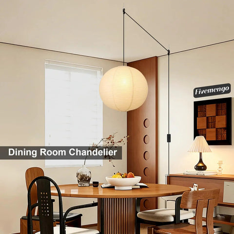 Twenty Inch Off White Japanese Rice Paper Lantern Plug In Pendant Light With Adjustable Cord Sets over a dining table in a cozy room setting.