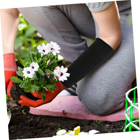 Person using Heavy Duty Cut Resistant Arm Guards And Thorn Proof Work Sleeves while planting flowers in the garden.