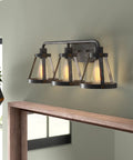 Wicker Park 3-Light Vanity Light Fixture in Weathered Pewter with Old Satin Brass Accents over modern bathroom mirror