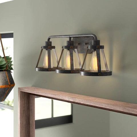 Wicker Park 3-Light Vanity Light Fixture in Weathered Pewter with Old Satin Brass Accents over modern bathroom mirror