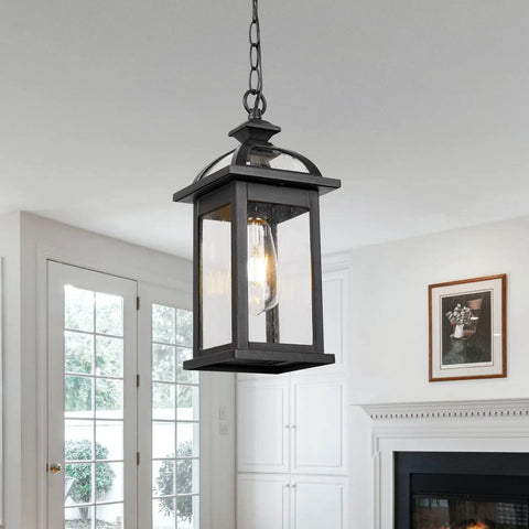 Weatherproof Outdoor Pendant Lantern in black with seeded glass, hanging in a living room setting, 13.6 inch tall, IP65 rated.
