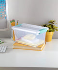 Sixteen Pack Clip Boxes Stackable Clear Plastic Storage Bins With Latching Lids on desk with books and stationery