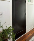 Smart Lock WiFi Bridge For Remote Access And Voice Assistant Control beside a door in a home interior