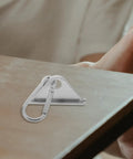 Top Notch Silver Aluminum Triangle Sliding Hooks For T Slot Tracks on a wooden surface, showcasing durability and secure design.
