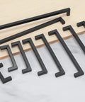 Matte Black Cabinet Pulls Five Pack Square Drawer Handles 9 1/4 Inch Total Length 236 Mm laid out on a surface