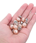 25Pcs No Sew Faux Pearl Brooch Pins Detachable Sweater Clips Reusable Shirt Fasteners held in a hand, showcasing the shiny pearl design.