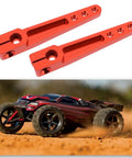 Two Pack 1.75 Inch 25T Aluminum Servo Arm Horns With Screws For Futaba Hitec Savox Power HD Servos Fits RC Airplanes And Cars Beefy Aluminum Servo Arms next to a racing RC car on dirt track.