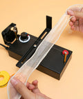 Electric Ribbon Cutter And Sealer with Adjustable Heat Range showing lace cutting in action, includes heating reels and US plug.