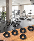 Five Rubber Pads For Shock Absorption And Vibration Control For Gym Equipment And Home Furniture displayed on a wooden table