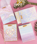 Colorful Marble Pattern Gift Bags With Tissue Paper And Gold Foil Accents, Medium Size 7x4x9 Inches, 4 Pack on pink background