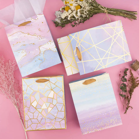 Colorful Marble Pattern Gift Bags With Tissue Paper And Gold Foil Accents, Medium Size 7x4x9 Inches, 4 Pack on pink background