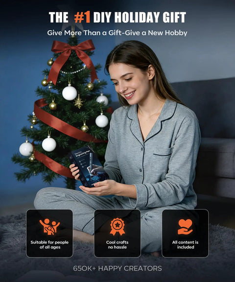 Person holding Engraving Pen Kit With LED Light And 31 Bits, Cordless Rechargeable Engraver; Christmas tree in background