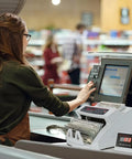 A retail worker using a Money Counter Machine With Value Count And Counterfeit Detection UV MG IR Large LCD Display Add And Batch Modes Fast And Accurate Cash Counter For Banks Or Small Biz Or Shops Includes US Plug.