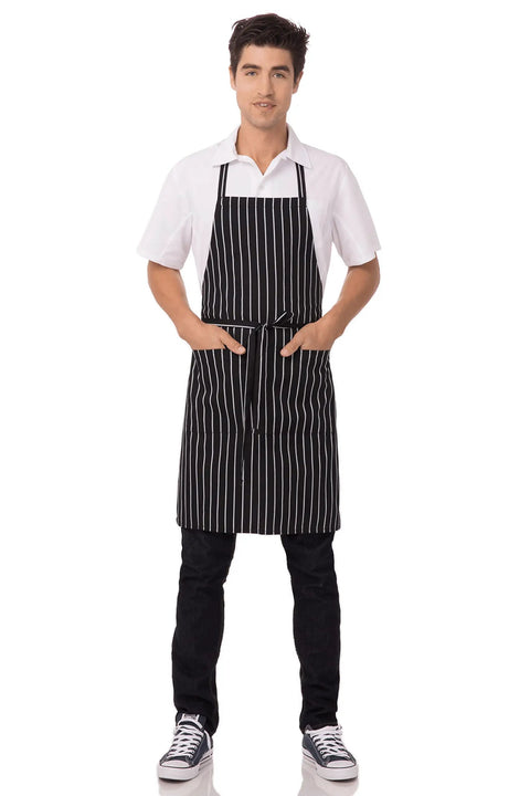 Man wearing black chalk stripe apron with reinforced stress points; Durable Unisex Kitchen Apron With Reinforced Stress Points And Comfy Waist Tie For Men And Women Heavy Duty Cooking Apron For Home Or Pro Everyday Kitchen Use