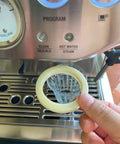 Hand holding 54 Millimeter Silicone Gasket Sealing Ring Compatible With Breville And Sage Espresso Machines 870 878 880