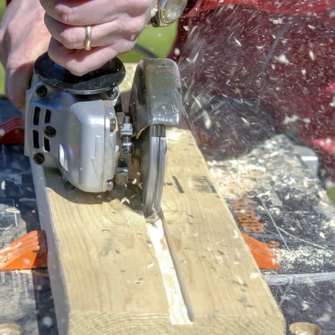 No Bull 4 Inch 14 Tooth Carving Saw Disc For Angle Grinders in use, cutting wood, showing detailed blade and tool action.