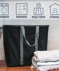 Collapsible Laundry Caddy 2 Pack 64L Cream Charcoal Foldable Laundry Basket beside folded clothes on counter top