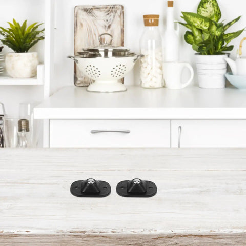 4pcs Small Furniture Adhesive Swivel Caster Wheels displayed on a kitchen counter, featuring a black design and easy installation.