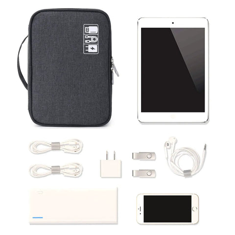 Waterproof Electronics Travel Organizer Bag With Double Layer Tangle Free Pockets beside tech gadgets like cables, tablet, and phone.