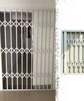Heavy Duty White Retractable Security Grille For Sliding Burglar Windows And Storage Sheds Featuring Smooth Operator Design in interior setting.