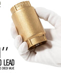 Close-up of 1-inch no-lead brass check valve with FNPT fittings held by gloved hand