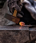 Blacksmith working with hammer and hot metal, using 17 Inch Carbon Steel Blacksmith Tongs Set, 2 Piece Pro Grade Forging Tongs.