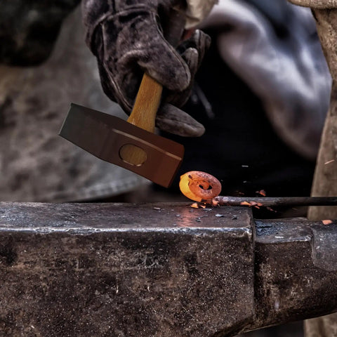 Blacksmith working with hammer and hot metal, using 17 Inch Carbon Steel Blacksmith Tongs Set, 2 Piece Pro Grade Forging Tongs.