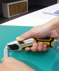 Auto Retractable Safety Utility Knife With Quick Blade Change Box Cutter And 4 Spare Blades Stored In Handle Beefy Zinc Alloy And Anti Slip Grip For Safe Quick Cutting held by hand