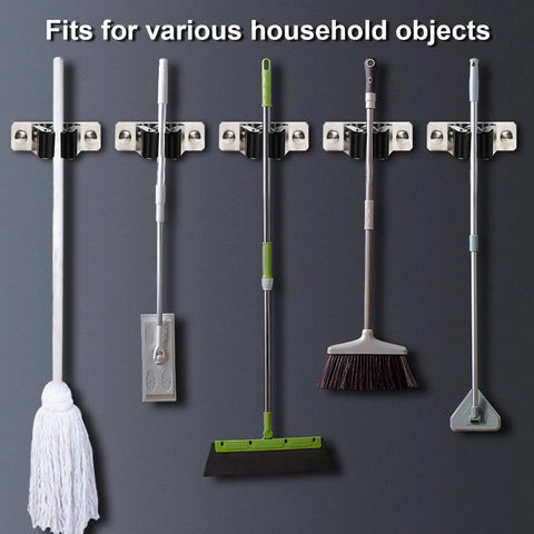 Heavy Duty Stainless Steel Mop And Broom Holder Wall Mount 2 Pack with various household tools attached