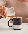 Fresh Golf Cart Magic Mug For Real Golfers Heat Changing Ceramic Coffee Cup 11 Oz being filled with coffee by a hand.