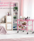 Rock Solid Heavy Duty Pink Metal Rolling Cart With Three Roomy Shelves And Smooth Rolling Wheels in a stylish living room.