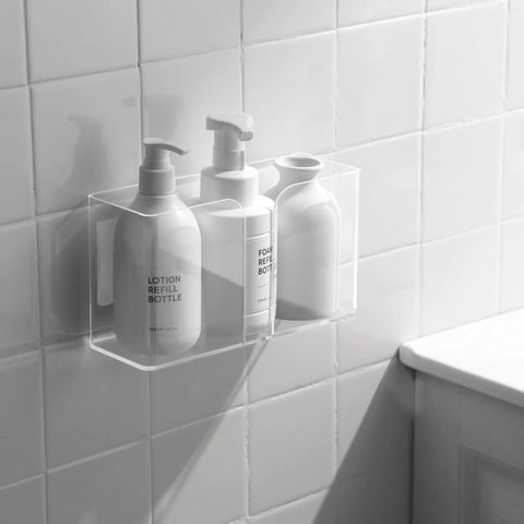 Bathroom wall with clear acrylic organizer holding three lotion bottles