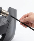 Person using heat tool to repair cracked car bumper with black PP welding rod from the 100 Pc Set to fix bumper quickly.