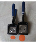 Two handheld button graphic punch die cutters with 32mm hardened steel dies, durable composite frames, and blue handles for badge making.