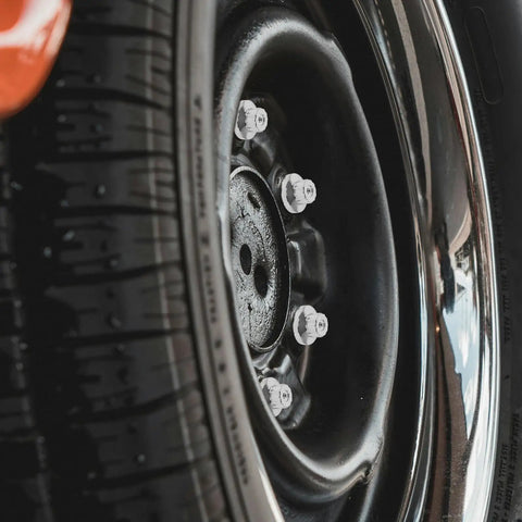 Five Piece Silver Steel Car Wheel Lug Nuts Set For Universal Tire And Rim Replacement Premium Rust Resistant Finish Bulletproof Hold No Drama Swap For Daily Drivers mounted on vehicle wheel.