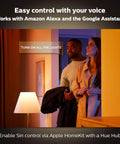 Gold Smart Table Lamp With White And Color Ambiance LED in a living room, showing easy control with Alexa and Google Assistant.