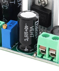 Close-up of High Voltage DC To DC Buck Converter Module LM2596HV showing capacitors and connection terminals.
