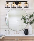 Industrial Farmhouse 4 Light Vanity Sconce With Vintage Edison Bulbs Black Metal Cage Shade mounted above bathroom vanity mirror